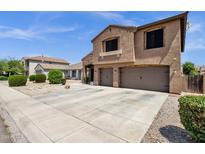 Attractive two-story home boasts stucco and brick exterior, three-car garage, and low maintenance yard at 1130 E Harvest Rd, San Tan Valley, AZ 85140