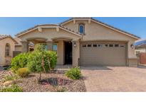 Charming single-story home featuring a well-manicured front yard and a two-car garage at 15078 W Mckinley St, Goodyear, AZ 85338
