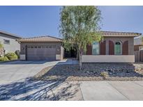 Charming single-story home featuring desert landscaping and a two-car garage at 16836 W Vereda Solana Dr, Surprise, AZ 85387