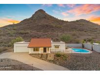 Charming single-story home with a red tile roof, mountain views, and a backyard pool at 1917 E Karen Dr, Phoenix, AZ 85022