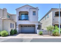 Contemporary two-story home featuring a balcony, a two-car garage, and desert landscaping at 281 E Shamrock Dr, Chandler, AZ 85286