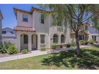 Charming two-story townhome with desert landscaping, arched entryways and tile roof at 3451 S Wren Dr, Gilbert, AZ 85297