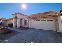 Charming single-story home featuring a well-maintained front yard and a two-car garage on a sunny day at 3853 W Calle Lejos --, Glendale, AZ 85310