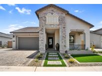 Charming home featuring a stone facade, meticulously landscaped front yard, and an attached garage at 3915 N Shannon Cir, Mesa, AZ 85215