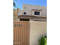 Charming two-story home featuring a gated entrance with house number 4743 on a sunny day at 4743 W Alice Ave, Glendale, AZ 85302