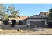 Charming single-story home featuring a two-car garage and low maintenance desert landscaping at 5403 W Novak Way, Laveen, AZ 85339
