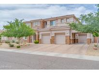 Beautiful stucco home featuring a three-car garage, manicured front yard, and stone veneer accents at 5542 W Big Oak St, Phoenix, AZ 85083