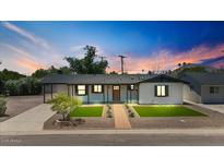 Charming home with a well-manicured front yard and a beautifully lit exterior at 6908 E Windsor Ave, Scottsdale, AZ 85257