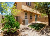 A cozy backyard area with low-maintenance landscaping and mature trees for shade at 1250 S Rialto -- # 78, Mesa, AZ 85209
