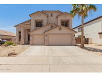 Two-story home with a neutral color palette, a two-car garage, and desert landscaping in the front yard at 14099 W Riviera Dr, Surprise, AZ 85379