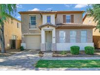 Charming two-story home featuring a neutral color scheme, attached garage, and well-maintained landscaping at 1420 E Sonrisas St, Phoenix, AZ 85040