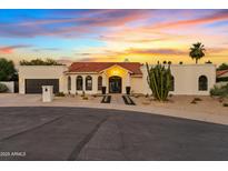 Stunning single-story home with beautiful desert landscaping and a red tile roof at sunset at 14401 N 60Th Pl, Scottsdale, AZ 85254