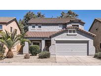 Charming two-story home featuring a well-maintained front yard and attached two-car garage at 15955 N Cristine Ln, Surprise, AZ 85388
