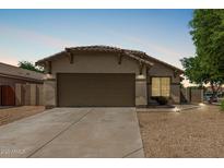Charming single story home featuring low maintenance desert landscaping and a two car garage at 17828 W Calavar Rd, Surprise, AZ 85388