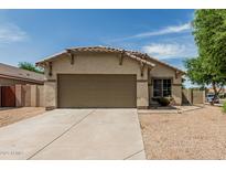 Charming single-story home with neutral stucco, tile roof, desert landscaping and a spacious two-car garage at 17828 W Calavar Rd, Surprise, AZ 85388