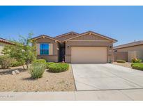 Charming single-story home with a well-manicured front yard and a two car garage at 18637 W Williams Rd, Surprise, AZ 85387