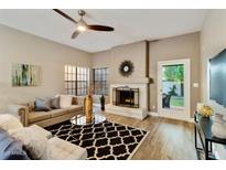 Bright living room features a fireplace, stylish furnishings, and views of the outdoor patio at 2110 W Navarro Ave, Mesa, AZ 85202