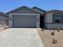 Charming single-story home featuring a spacious two-car garage and low-maintenance desert landscaping at 22913 N 183Rd Dr, Surprise, AZ 85387
