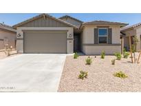 Charming single-story home featuring a two-car garage, neutral color palette, and desert landscaping at 22913 N 183Rd Dr, Surprise, AZ 85387