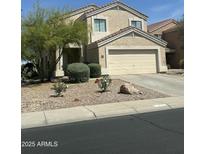 Inviting two-story home featuring a two-car garage and low-maintenance landscaping at 23284 W Pima St, Buckeye, AZ 85326