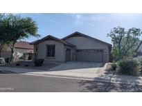 Inviting single-story home featuring desert landscaping, stone accents, and a two-car garage at 31138 N 130Th Ln, Peoria, AZ 85383