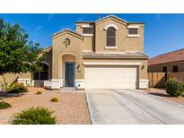 Two-story home with desert landscaping, neutral paint, arched entryway, and two-car garage at 35919 N Loemann Dr, San Tan Valley, AZ 85143