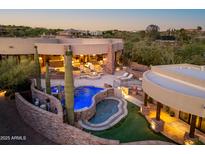 Stunning backyard with a multi-tiered pool, spa, and outdoor entertaining area perfect for relaxation and gatherings at 41667 N 113Th Pl, Scottsdale, AZ 85262