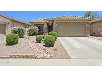 Inviting single-story home with a well-manicured, desert-landscaped front yard and neutral color palette at 45042 W Cypress Ln, Maricopa, AZ 85139