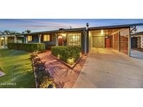 Charming home featuring a landscaped front yard, inviting brick pathway, and covered parking area at 4610 N 14Th Ave, Phoenix, AZ 85013