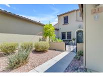 Inviting front yard with a small patio and beautiful desert landscaping leading to the home's entryway at 4700 S Fulton Ranch Blvd # 11, Chandler, AZ 85248