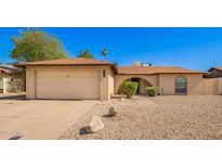Charming single-story home with a two-car garage and low-maintenance desert landscaping at 4957 W Onyx Ave, Glendale, AZ 85302
