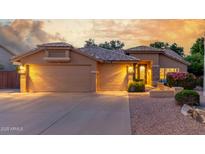 Inviting home featuring a three car garage and decorative iron work on front door at 6918 W Villa Hermosa W --, Glendale, AZ 85310