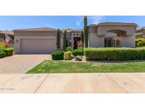 Charming single-story home with stucco exterior, desert landscaping and a paver driveway at 8689 E Krail St, Scottsdale, AZ 85250