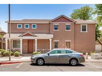 Two-story home featuring neutral paint, covered porch, and low-maintenance landscaping in a desirable location at 89 E Palomino Dr, Gilbert, AZ 85296