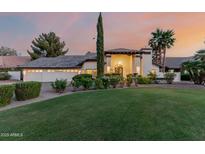 Stunning single-story home with lush lawn, manicured landscaping, and grand entrance with decorative columns at 9921 E Doubletree Ranch Rd, Scottsdale, AZ 85258