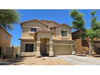 Charming two-story home featuring a welcoming front porch and a well-manicured yard at 10036 W Chipman Rd, Tolleson, AZ 85353
