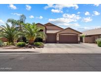 Charming two-story home with a three-car garage and mature desert landscaping at 11253 E Peterson Ave, Mesa, AZ 85212