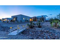 Desert home featuring a white bridge with desert landscaping at twilight at 14332 E Bobwhite Way, Scottsdale, AZ 85262