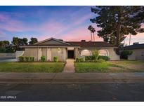 Charming single story home with manicured lawn and mature trees in residential neighborhood at 1509 W Kiowa Ave, Mesa, AZ 85202