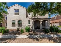 Charming two-story home with a covered front porch and manicured landscaping, great for curb appeal at 1700 S Martingale Rd, Gilbert, AZ 85295