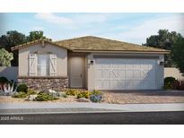 Charming single-story home featuring stone accents, a two-car garage, and a welcoming front yard at 17586 W Monroe St, Goodyear, AZ 85338