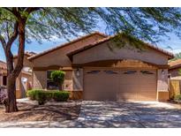 Charming single-story home featuring a two-car garage and well-maintained front yard landscaping at 2556 W Amber Sun Dr, Phoenix, AZ 85085