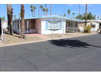 Charming manufactured home with a covered carport and well-maintained landscaping at 303 S Recker Rd # 78, Mesa, AZ 85206