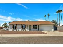 Charming single-story home featuring a well-manicured yard and attached two car garage at 3614 W Danbury Dr, Glendale, AZ 85308
