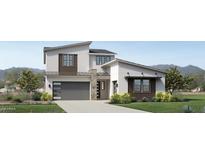 Modern two-story home with a gray garage door and stone accents at 3672 W Horse Trail Way, San Tan Valley, AZ 85144