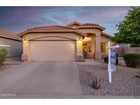 Charming single-story home featuring a tile roof, arched entryway, and a two-car garage at 3713 W Nancy Ln, Phoenix, AZ 85041