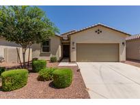 Charming single-story home featuring a low-maintenance yard and a two-car garage in a residential neighborhood at 40066 W Jenna Ln, Maricopa, AZ 85138