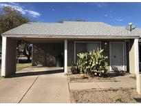 Charming home featuring a quaint front yard with native desert landscaping and a convenient covered parking area at 4042 E Carson Rd, Phoenix, AZ 85042