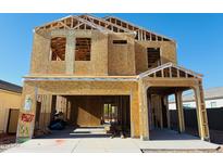 New construction home featuring a two-story framed structure, open garage, and visible interior framework at 5024 E Umber Rd, San Tan Valley, AZ 85143