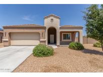 Charming single-story home with a neutral color scheme, desert landscaping, and a covered porch at 5039 S 237Th Ln, Buckeye, AZ 85326